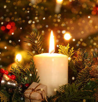 bernhardlux burning advent candle Christmas decoration with flare lights in front of a Christmas tree